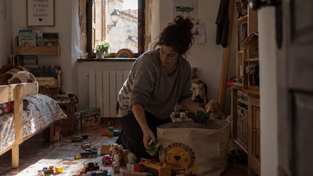 Empleada de hogar trabajando en la habitación de los niños en una vivienda de Cáceres